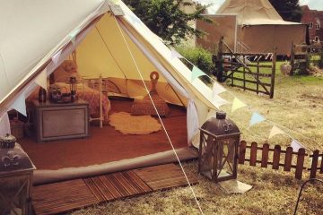 Side view of a bell tent with picket fencing